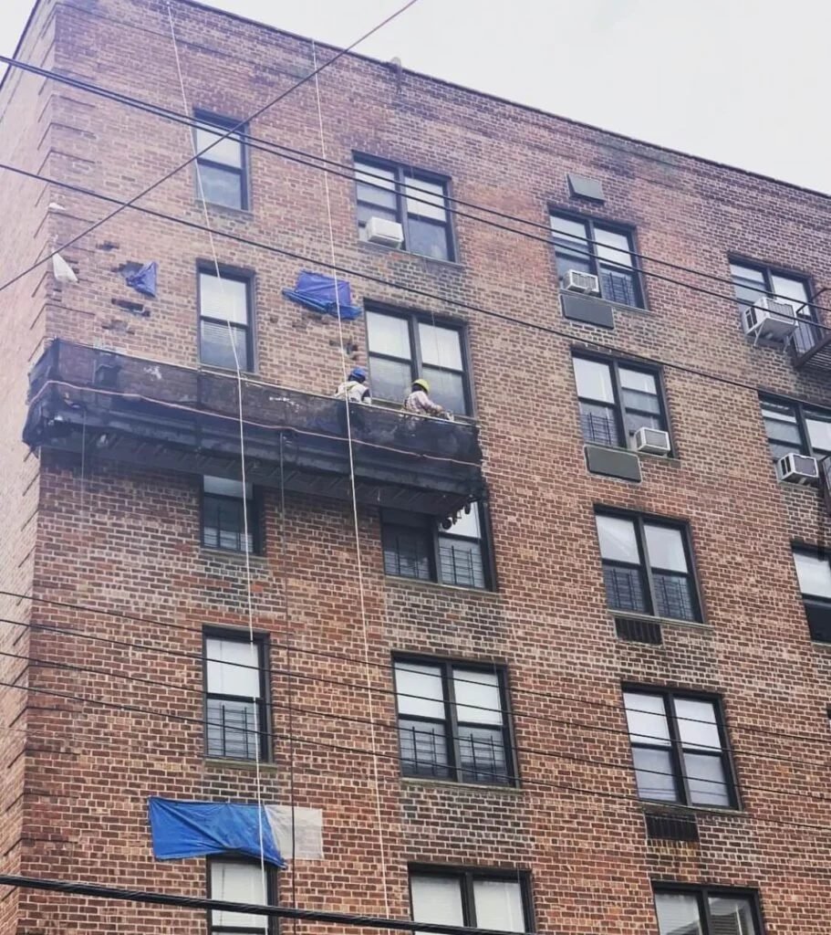 Brick facade with a suspended scaffold drop
